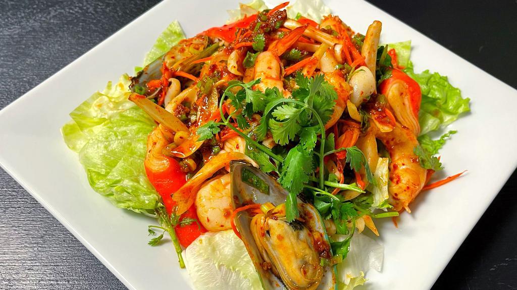 Yum Seafood · Shrimp, mussels, scallop, crab, squid marinated in lime juice, chili, onions, cilantro, carrots and served on bed of lettuce