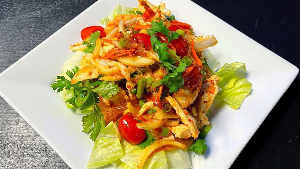 Yum Wun Sen · A mixture of bean threads, three prawns, chicken with lime juice, chili, onions, cilantro, tomatoes, carrots, and served on a bed of lettuce.