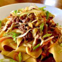 Beef Chow Fun · Wide noodles tossed with cabbage, carrots, onions, sprouts, green onions, and then seared in...