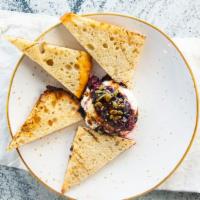 Ricotta Toast · grilled focaccia, balsamic blueberries, local honey, nuts & seeds, balsamic glaze