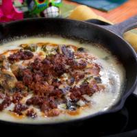 Queso Fundido · Melted Oaxaca cheese topped with chorizo, sauteed mushrooms and roasted poblano peppers. . S...