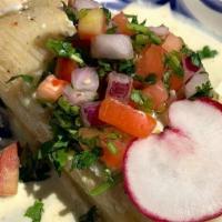 Tamale - Veggie · Vegetable and Oaxaca cheese tamale topped with our Queen's cream sauce.