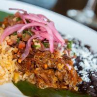 Cochinita Pibil Entrada · The Queen's acclaimed pork is marinated in sour orange and achiote paste, wrapped in a banan...