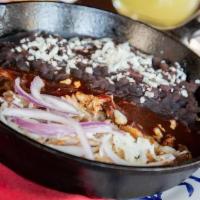 Carnitas Michoacanas Entrada · Slow-cooked pork marinated in Coca-Cola ™ and orange rind with red chile sauce, epazote blac...