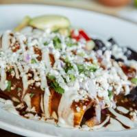 Carne Asada Enchiladas · Grilled steak marinated in fresh orange and garlic with Oaxaca cheese. . Topped with a combi...