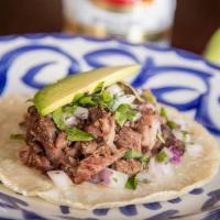 Carne Asada Taco · Grilled steak marinated in fresh orange and garlic. . Topped with diced red onions, fresh ci...