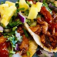 Al Pastor Taco · Pork marinated in chile and spice. . Topped with diced red onions, fresh cilantro, pineapple...