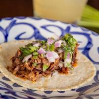 Suadero Azteca Taco · Delicately slow-cooked beef short rib topped with red onions and fresh cilantro.