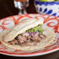 Carne Asada Y Huevo Taco · Grilled steak marinated in fresh orange and garlic. . Topped with a fried egg, diced red oni...
