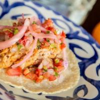 Cochinita Pibil Taco · The Queen's acclaimed pork marinated in sour orange and achiote paste. . Topped with pickled...