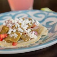 Nopalitos Taco · Tender sauteed cactus, jalapeno peppers, red onions and tomatoes.. Topped with queso fresco.
