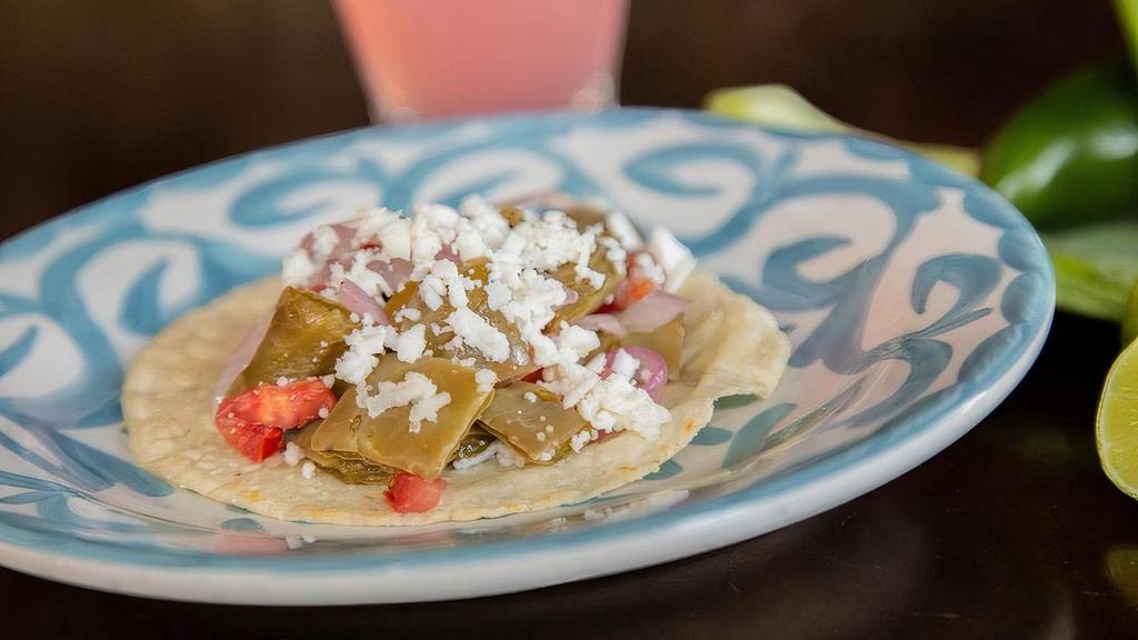 Nopalitos Taco · Tender sauteed cactus, jalapeno peppers, red onions and tomatoes.. Topped with queso fresco.