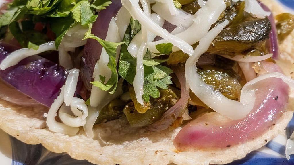 Rajas Taco · Roasted poblano peppers and sauteed red onions. . Topped with fresh cilantro and Oaxaca cheese.