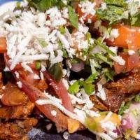 Alambre Beef Taco · Skirt steak marinated in our homemade three peppers red sauce and spices. Topped with pico d...