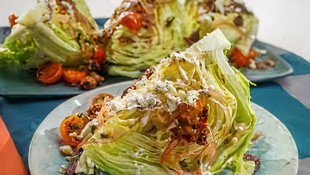 Iceberg Wedge Salad · Gluten-Free. Egg, bacon, blue cheese crumbles, Red onion, tomatoes with blue cheese dressing.