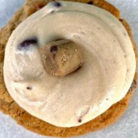 Frosted Cookie Dough Cookie · Large chocolate chip cookie with chocolate chip cookie dough frosting topped with a cookie d...