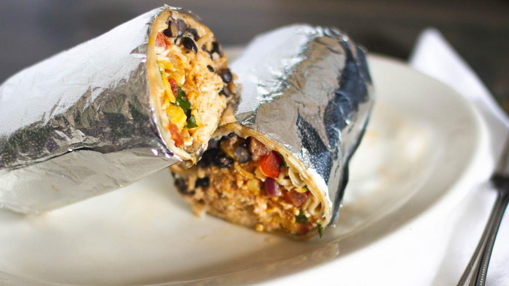 Burrito · Large flour tortilla rolled with rice, beans, your choice of meat and your choice of veggies.