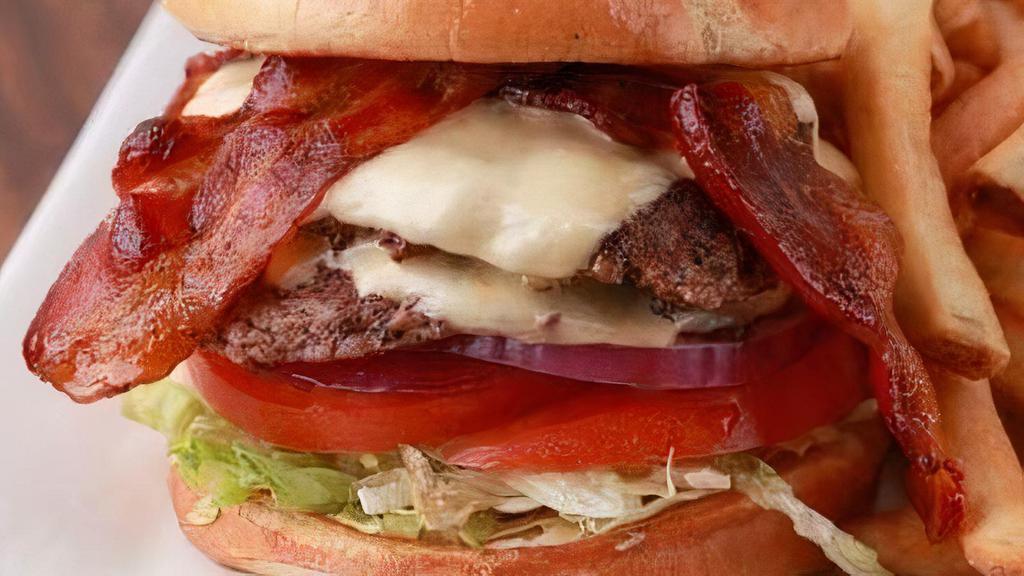 Chuck Burger · 6 ounce Creekstone fresh burger with lettuce, tomato, pickle, onion topped with crisp bacon and melted white American cheese.