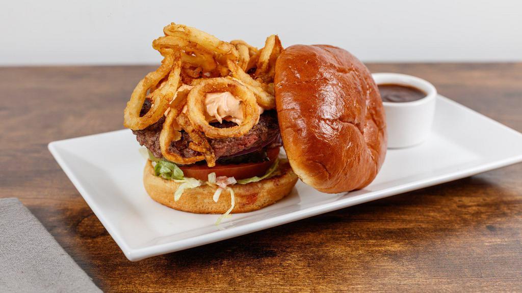 The Alamo Burger · 6 ounce Creekstone fresh burger with lettuce, tomato, pickle, onion topped with spicy chipotle cream cheese and crispy frizzled onions.