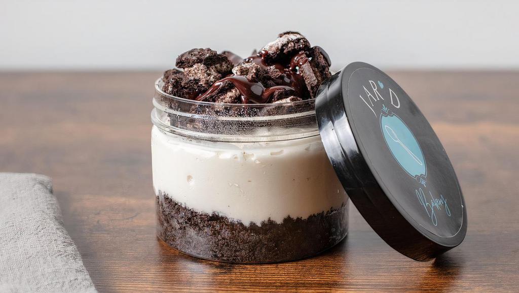 Oreo Cheesecake Jar  · Creamy Vanilla Cheesecake on chocolate oreo crust, with layers of oreo crumbles and fudge.