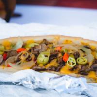 The Works Cheesesteak · Ribeye steak, grilled onions, green peppers, mushrooms, hot peppers, and cheese whiz.