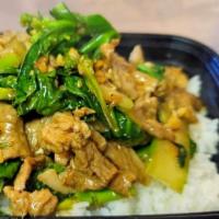 Kow Rad Ka-Na Moo · Stir-fried pork with Chinese broccoli in garlic sauce over rice.
