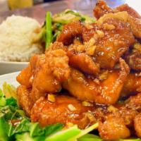 Gai Ob Yod Puk · Stir-fried crispy chicken with garlic in sweet & sour sauce served over Chinese broccoli com...