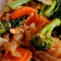 Pad See Ew · Wide rice noodles stir-fried with egg, broccoli, carrots, and Chinese broccoli in sweet soy ...