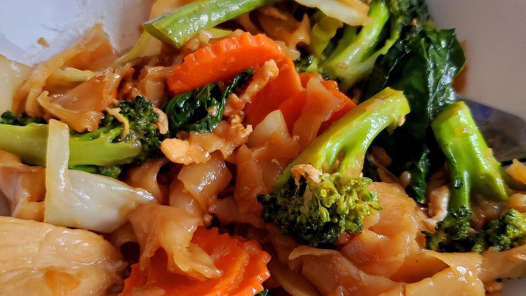 Pad See Ew · Wide rice noodles stir-fried with egg, broccoli, carrots, and Chinese broccoli in sweet soy sauce.