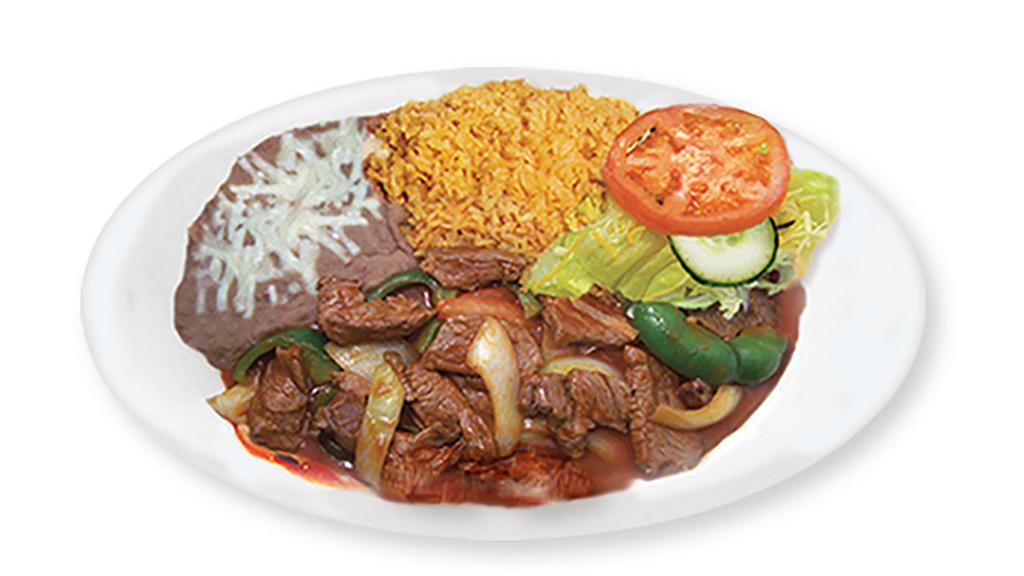 Steak Ranchero · Tender steak slices cooked in a spicy sauce with onions, bell peppers, tomatoes and spices. With rice, beans, salad and tortillas. No extra meat or substitutions without paying or written on special instructions.