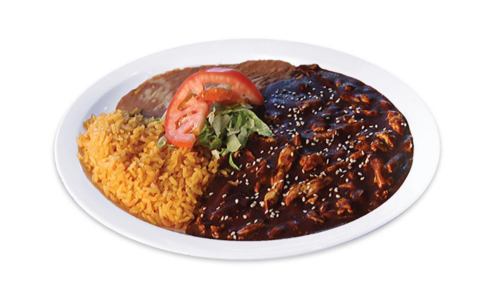 Pollo En Mole · Chicken breast strips cooked in a spicy mole sauce, mushrooms and onions. Garnished with lettuce and tomato. Spicy, not sweet. No extra meat or substitutions without paying or written on special instructions.