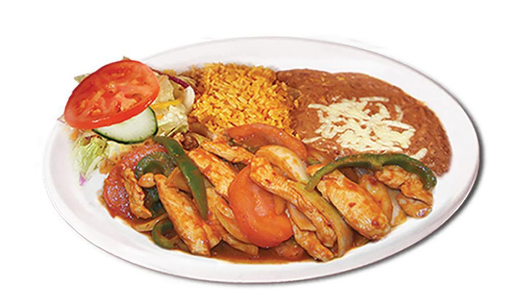 Pollo Ranchero · Spicy! Chicken breast strips, onions, tomato, red and green bell peppers in a spicy and very tasty sauce. Garnished with lettuce and dice tomato.