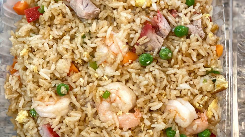 Young Chow Fried Rice · Barbecue pork and shrimp mixed with eggs, peas and carrots.