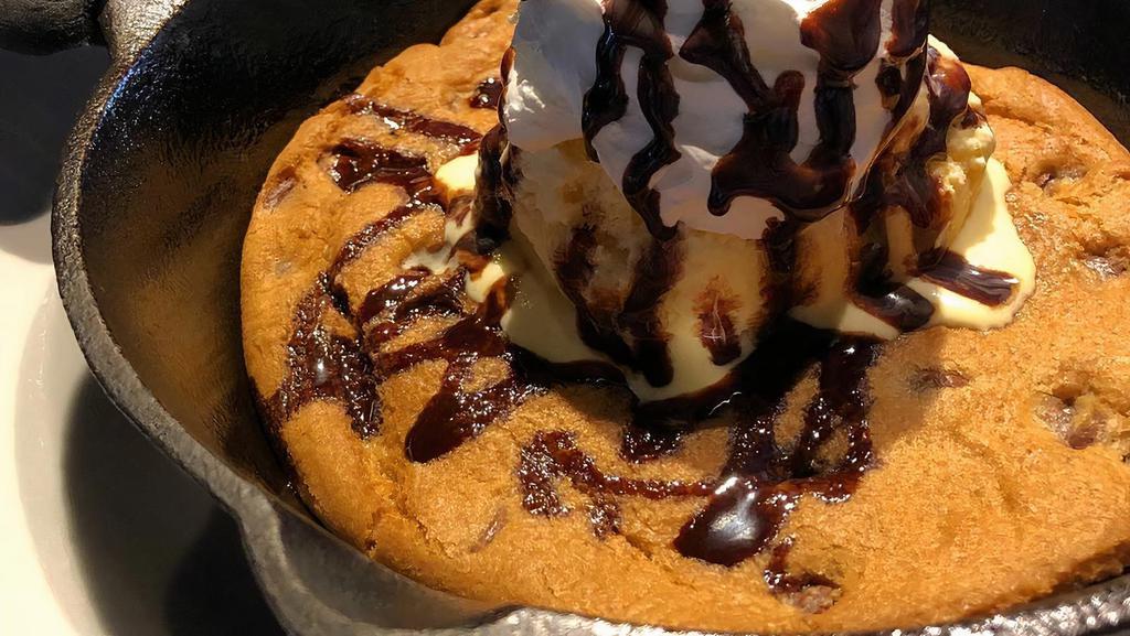 Skillet Cookie · A giant chocolate chip cookie served in a super hot cast iron skillet. Topped with a scoop of local vanilla bean ice cream.
