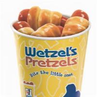 Dog Bites · A whole pile of mini Wetzel dogs, made with mini 100% all-beef hot dogs.