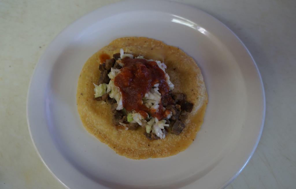 Taco With Carne Asada · Hand made tortilla, pico de gallo (cabbage, tomato, onion and cilantro) and red mild sauce.