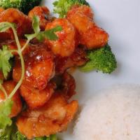 Orange Chicken · Crispy chicken tossed in a savory orange sauce. Served with white rice and broccoli.