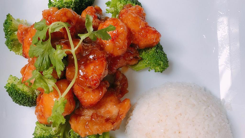 Orange Chicken · Crispy chicken tossed in a savory orange sauce. Served with white rice and broccoli.