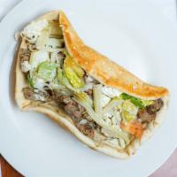 Gyro · Tender marinated meat wrapped in freshly baked flatbread with lettuce, onion, tomatoes, feta...