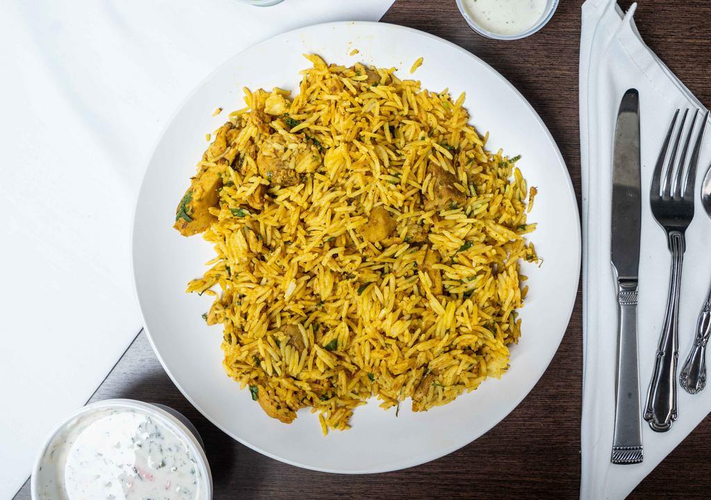 Chicken Biryani · Heavenly tasting, the most famous royal entrée of rice pilaf cooked with marinated juicy and tender meat.