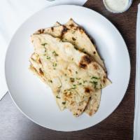 Garlic Naan (1 Pc.) · The perfectly proportioned flavor of garlic in freshly baked wheat bread in traditional clay...