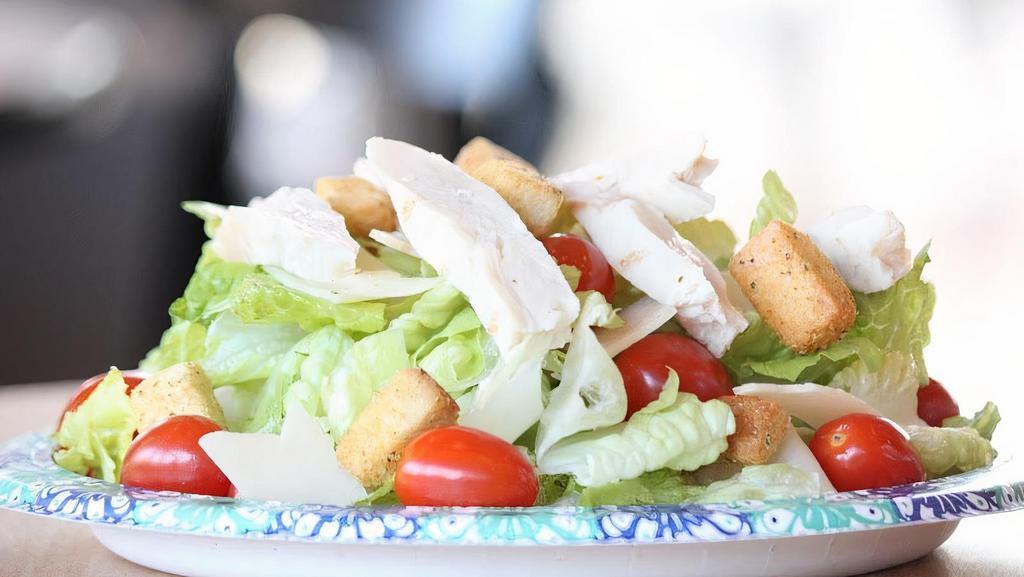 Chicken Caesar Salad · Romaine Lettuce, Tomatoes, Grilled Chicken Breast, Parmesan Cheese, Served with Pack of Croutons.
