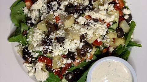 Greek (Gf) · Chopped romaine, sun-dried tomatoes, cucumber, black olive, red peppers, artichoke, and feta ~ served with our garlic feta dressing. Gluten-free.