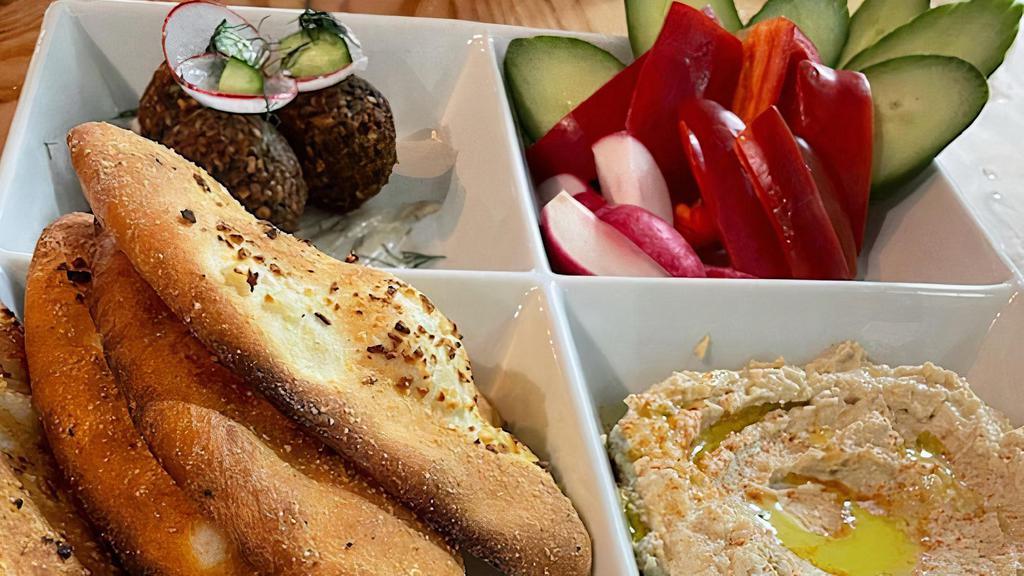 Hummus Platter  · Hummus, Crisp vegetables, Falafel (3) in tahini sauce, house baked organic bread.  (vegan)
