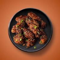 Heat Waves · 6 golden fried wings in an extra hot hell juice. Served with a side of blue cheese or ranch.