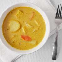 Yellow Curry+Rice · Yellow curry with coconut milk, potatoes, onion, and carrots.