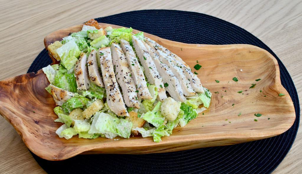 Chicken Caesar Salad · Grilled chicken breast, romaine, croutons, Caesar dressing, and Parmesan cheese.