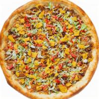 Crunchy Taco Pizza · Signature Black Bean Spread, Taco Seasoned Ground Beef, Shredded Lettuce, Fresh Tomatoes, Cr...