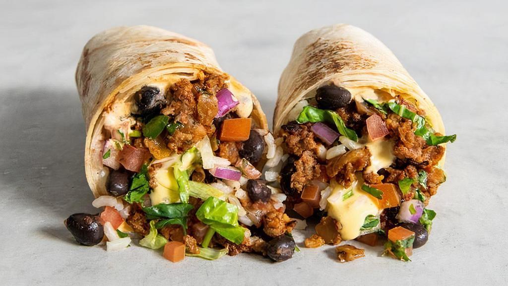 Tejano Style Burrito · Impossible ™ seasoned tex-mex style taco meat, with red rice, ranchero beans, queso sauce, shredded lettuce, cilantro, pico de gallo, and Cholula crema. | 860 cals.                   .