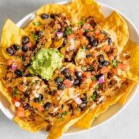 Mas Nachos · Crispy tortilla chips topped with Impossible ™ savory tex-mex style taco meat, queso sauce, ...
